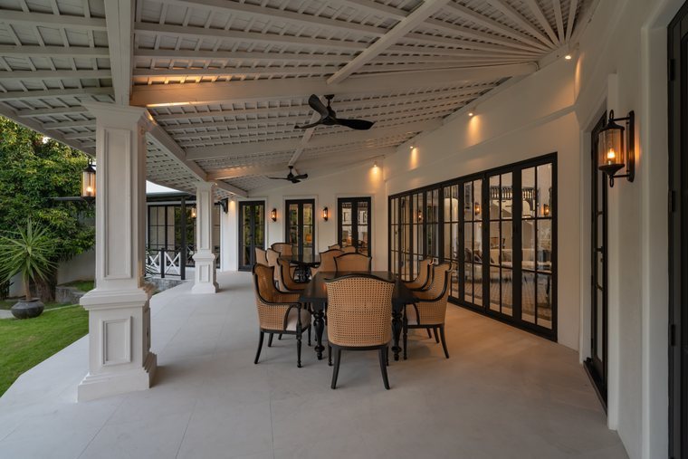Luxurious Lounge with dining tables for 12 people and views on a lush garden at Aranaya Residence
